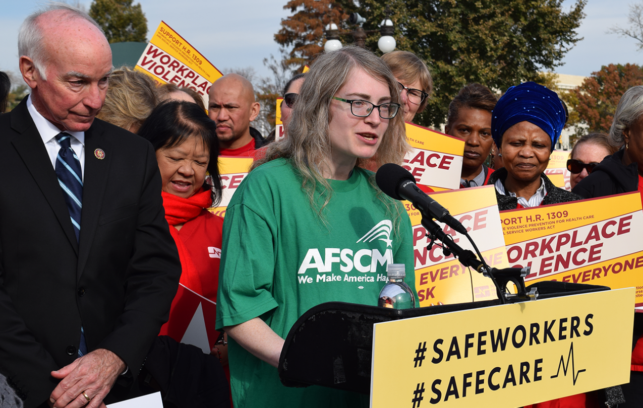 AFSCME member and social worker Miriam Doyle speaks at rally with Rep. Joe Courtney